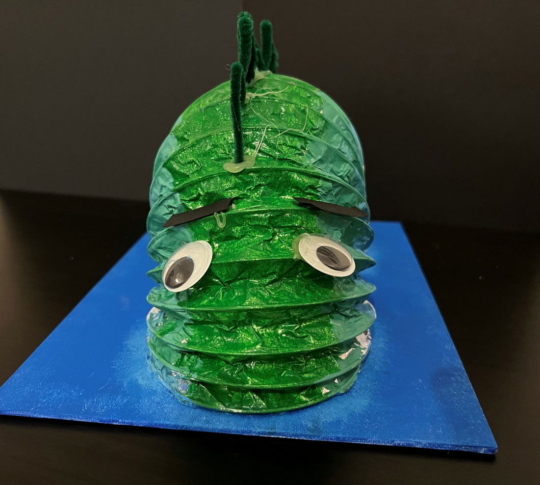 A child's green Loch Ness Monster sculpture.
