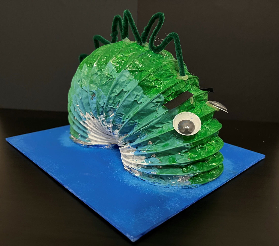 Another picture of a child's green Loch Ness Monster sculpture.
